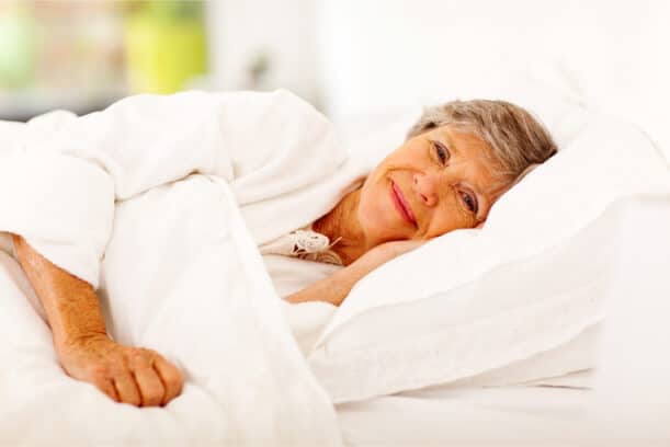 An elderly woman in bed