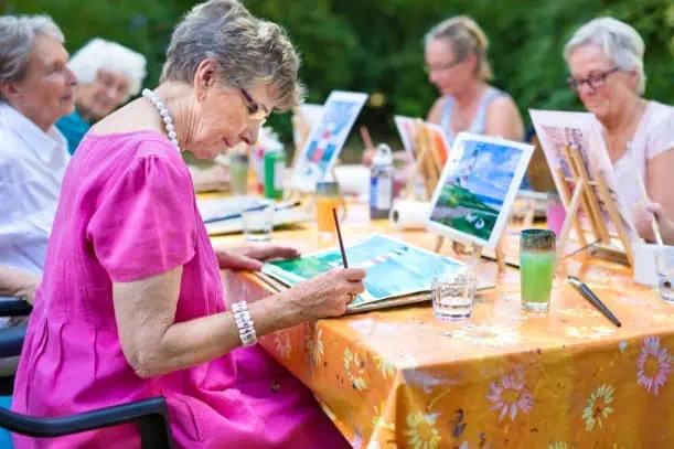 A group of senior citizens painting together