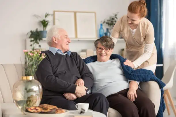 Two senior citizens with a caregiver