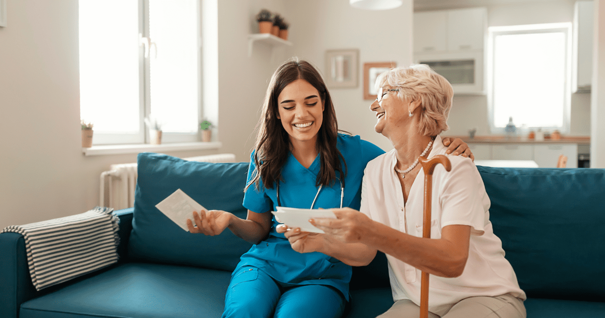 A caregiver looking at pictures with a senior citizen