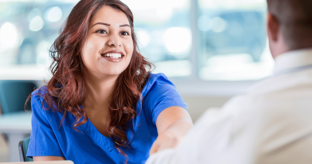 A caregiver wearing blue scrubs